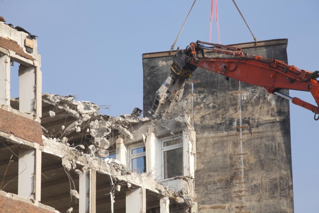 Demolition Bryan-College Station Texas - House or Building Demolition 2 "a crane is lifting a building up into the air"