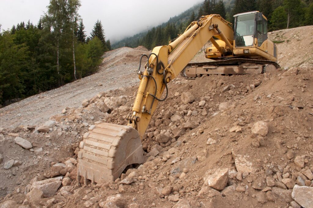 Demolition Bryan-College Station Texas - Land Clearing & Grading 2 "a bulldozer digging through a pile of dirt"