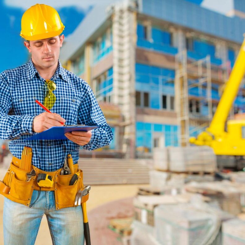 "a man wearing a hard hat and holding a clipboard"